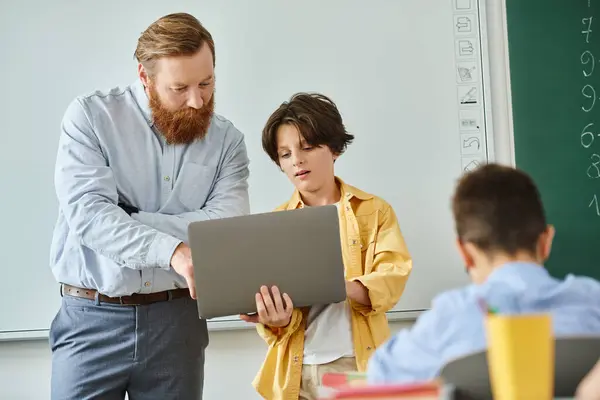 Man Stands Confidently Front Laptop Teaching Group Kids Bright Classroom — Foto Stock