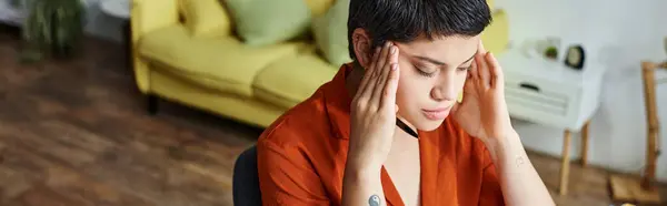 stock image concentrated tired woman with short hair and tattoo with hands on her temples, education, banner