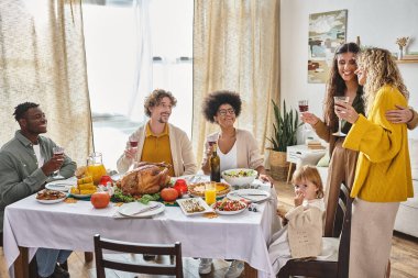 multicultural friends celebrating Thanksgiving with lgbt family and toddler baby girl, gathering clipart