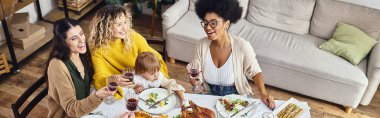 Happy Thanksgiving, joyful multiethnic women and baby girl having a good time together, banner clipart