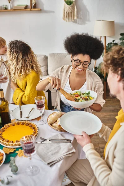 stock image cheerful family enjoying delicious dinner while gathering on Thanksgiving, roasted turkey on table