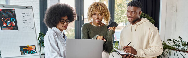 team of young friends working on their project with graphics on backdrop, business concept, banner