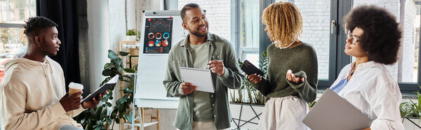 jolly team of friends working on their project with graphics on backdrop, business concept, banner