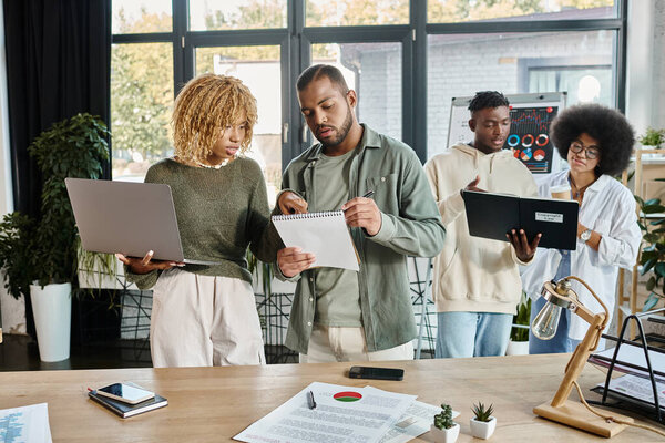 cheerful team of young friends in casual outfits joyfully discussing their project, business concept