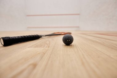 ball and racquet inside of squash court with white walls, motivation and determination concept clipart