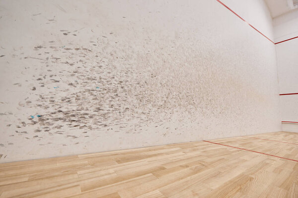 spacious and modern squash court with white walls, motivation and determination concept