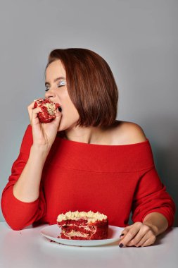 young woman in red attire biting delicious piece of bento cake on grey background, Happy Birthday clipart