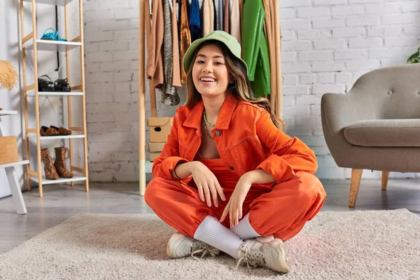 Young Asian Stylist Panama Hat Orange Clothes Sitting Floor Smiling — Stock Photo, Image