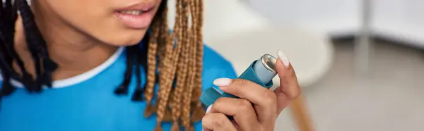 stock image ill african american patient using her asthma inhaler in hospital ward, healthcare, cropped, banner