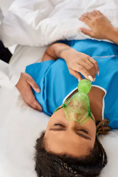 stock image cropped view of doctor comforting ill african american woman lying in hospital bed with oxygen mask