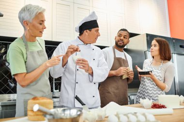 diverse people in casual attires with aprons listening to mature chef attentively, cooking courses clipart