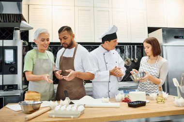 multiracial students in casual attires learning how to bake next to mature chef, cooking courses clipart