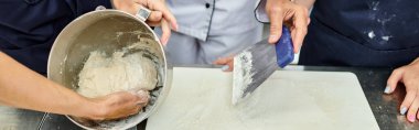 cropped view of mature chief cook showing his chefs how to work with dough, confectionary, banner clipart