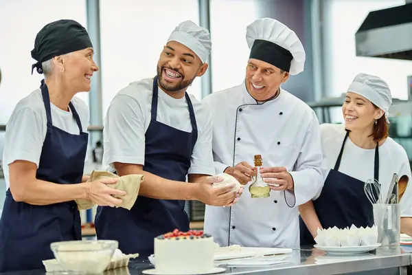 handsome african american chef with braces working with dough next to jolly chief cook and friends