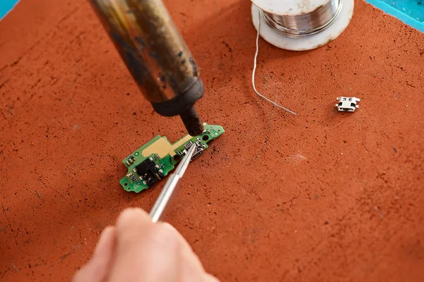 stock image cropped view of experienced technician desoldering electronic microscheme in private workshop