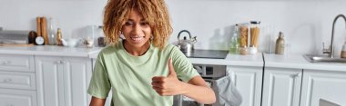 happy african american woman showing thumb up during video call on laptop, like gesture banner clipart