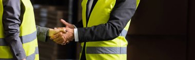 cropped shot of supervisor and his colleague shaking hands, agreement about working process clipart