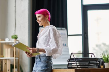 cheerful attractive female worker holding her notes at office and smiling happily, business concept clipart