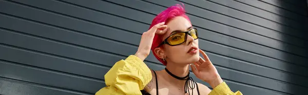 stylish chic woman with pink hair and tattoo posing in sunglasses and trendy streetwear, banner