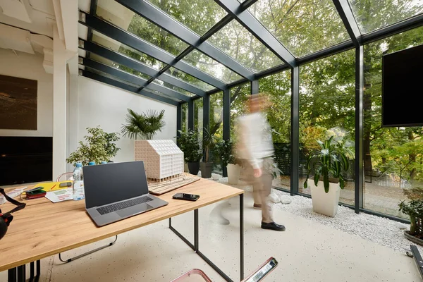 stock image long exposure photo of hardworking coworkers moving around their office, startup, motion blur