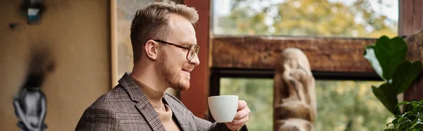 stock image jolly sophisticated business leader with glasses in elegant suit drinking his hot coffee, banner