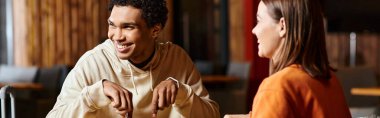 A well-dressed black man exudes joy as he laughing near girlfriend in a cozy indoor setting, banner clipart