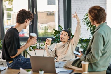 Joyful team member expressing a bright idea during a coffee break at the office, startup clipart