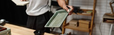 banner of young african american photographer expertly handles film tray in a modern analog darkroom clipart