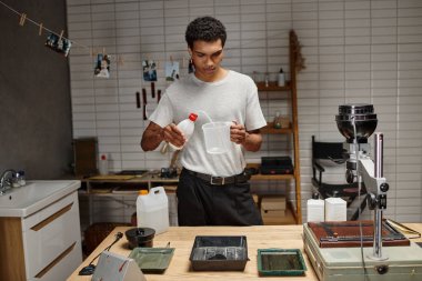 Genç Afrikalı Amerikalı fotoğrafçı profesyonel bir karanlık odada analog film geliştirme işine girdi.