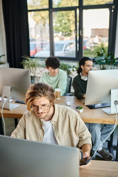 stock image Focused man working on creative project and looking at monitor in office, post production team