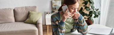 Mutlu genç kız evden internetten okurken telefon ediyor, yatay afiş.