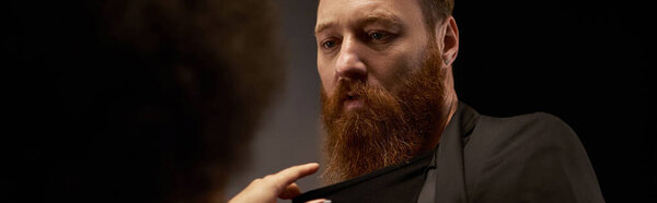 african american woman in dress pulling blazer of bearded man during date, sexy couple banner