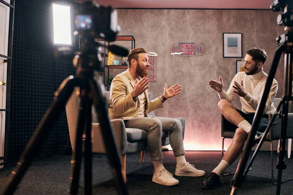 stock image handsome stylish men with dapper style sitting and discussing interview questions in studio