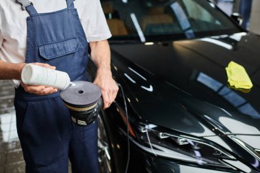 Özel makineye cilalama macunu uygulayan üniformalı kendini işine adamış bir askerin görüntüsü