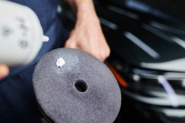 cropped view of devoted hard working serviceman in uniform applying paste on polishing machine clipart