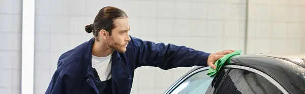 stock image good looking professional worker with collected hair in uniform cleaning black modern car, banner