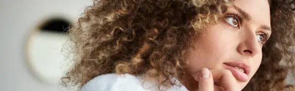 stock image Closeup portrait of curly beautiful young  woman wearing white robe and looking away, banner