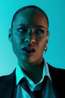 Young African American woman with glasses and a suit, exuding confidence and intelligence clipart