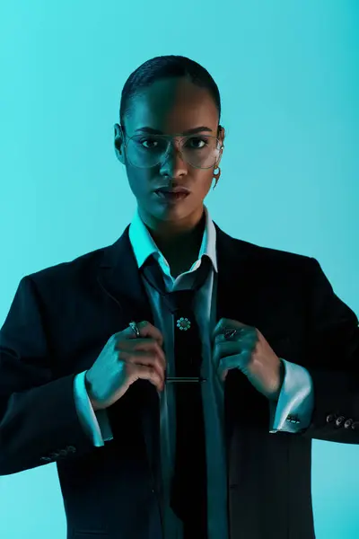 stock image Young African American in a suit and tie, confidently standing against vibrant blue background