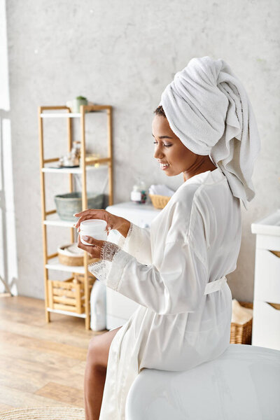 An African American woman with afro braids sits gracefully on a chair in her modern bathroom, exuding beauty and hygiene.