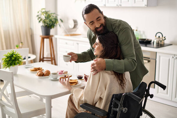 cheerful attractive woman with disability in wheelchair eating breakfast with her loving husband