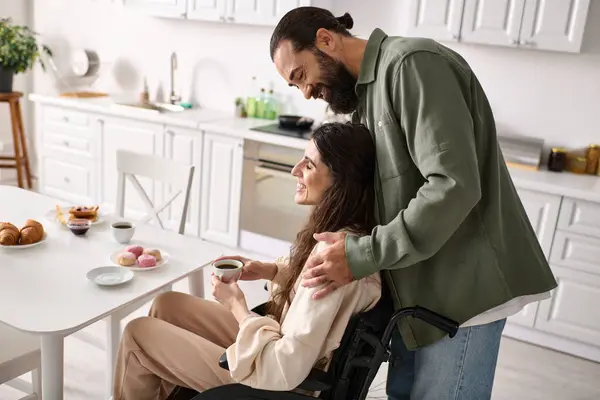 ポジティブな愛する男は車椅子で彼の障害のある美しい妻と朝食で時間を過ごします — ストック写真