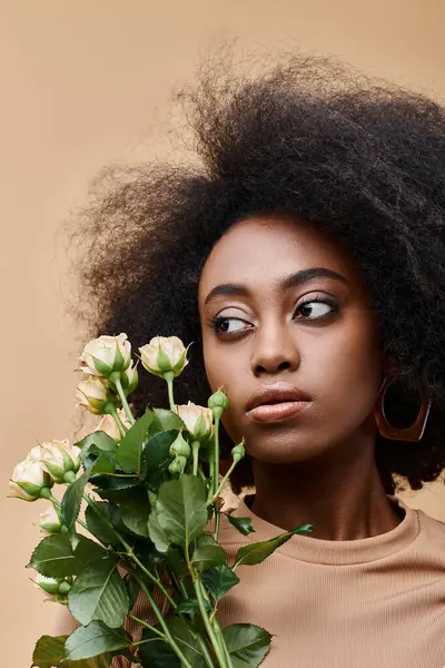 Young Curly African American Woman Holding Tiny Flowers Beige Background — Stock Photo, Image