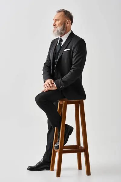 Middle Aged Groom Elegant Suit Sits Stool Studio Setting Exuding — Stock Photo, Image