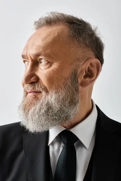 stock image A middle-aged groom in an elegant suit and tie in a studio setting on his wedding day.