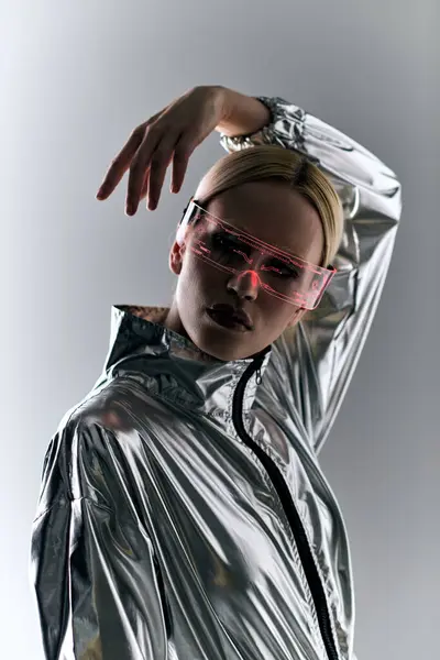 stock image peculiar woman with sci fi glasses in futuristic attire doing robotic motions and looking at camera