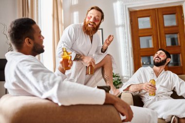 Three cheerful men of diverse backgrounds share laughs in a cozy living room while wearing bathrobes. clipart