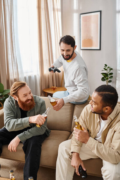 Three cheerful, interracial men in casual attire, bonding and relaxing on top of a couch at home.