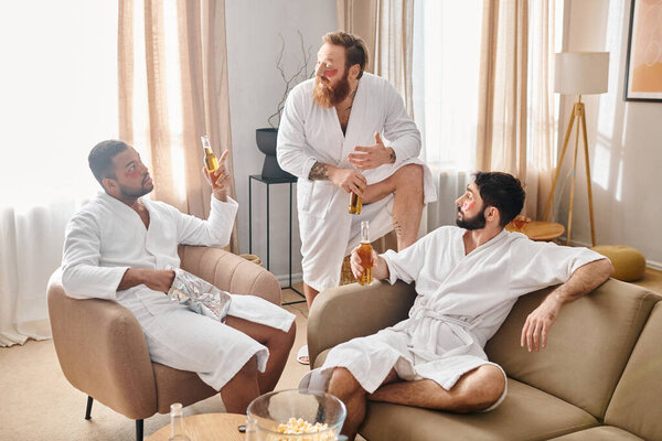 Diverse, cheerful men in bathrobes bond joyfully on top of a couch in a moment of friendship and camaraderie.