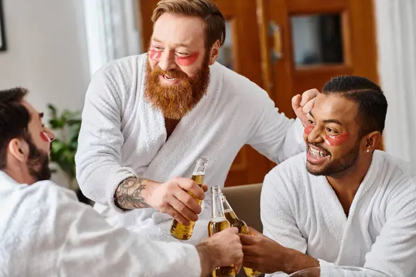 Three Cheerful Men Bathrobes Enjoying Drinks Camaraderie Table — Stock Photo, Image
